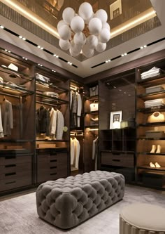 a large walk in closet with lots of clothes