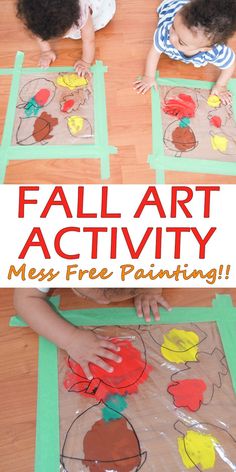 two children playing with fall art activity on the floor