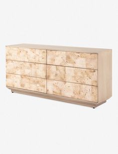 an image of a wooden dresser with marbled drawers on it's sideboard