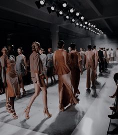 a group of people walking down a runway