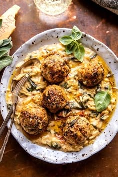 a white bowl filled with pasta and meatballs