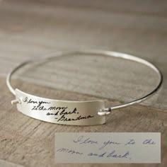 a silver bracelet with handwriting on it