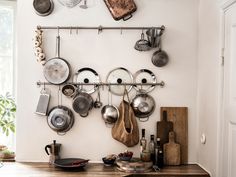 pots and pans are hanging on the wall