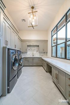 a washer and dryer in a very large room with lots of counter space