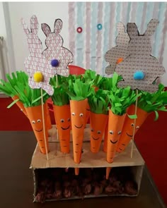 carrots with faces made out of paper and grass