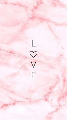 the word love written in black ink on a pink marble background with a white heart