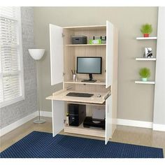 a computer desk with a monitor, keyboard and mouse