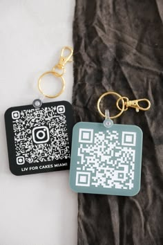 two key chains with qr code tags attached to them