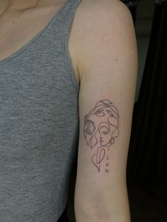 a woman's arm with a tattoo on it that has a drawing of a woman