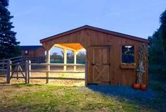 a horse barn with a wooden door and windows