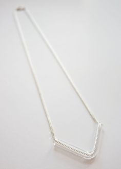 Minimal Glass Tube Necklace No. 6- Each piece is handmade producing similar yet one of a kind results. - Borosilicate glass tube in small V shape. Measures approx. 1.75 x 1.25". - Displayed on your choice of gold or silver plated brass chain. Measures 22". See more of my glass necklaces here: https://www.etsy.com/shop/UrbanRevisions?section_id=12314363-------------------------------------------------------------------Made to order : product will ship within 7 business days. Please read shop poli Tube Necklace, Dot Ring, Brass Chain, Glass Necklace, Etsy Fashion, Unique Necklaces, V Shape, Jewelry Stores, Arrow Necklace