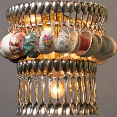 a chandelier with spoons and cups hanging from it