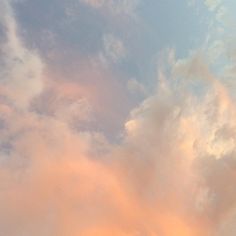 an airplane is flying in the sky at sunset or dawn with some clouds above it