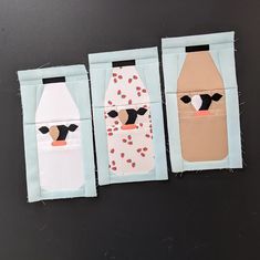 three pieces of paper cut out to look like milk bottles