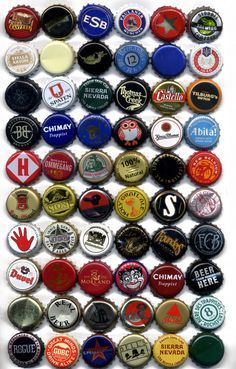 many different types of beer bottle caps are arranged together