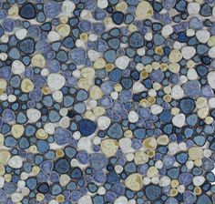 a close up view of some blue and white circles on a tile flooring pattern