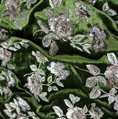 green velvet with silver flowers and leaves embroidered on the side, closeup shot in full frame