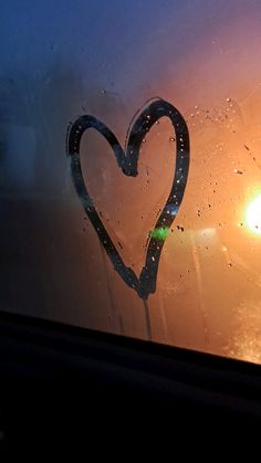 a heart drawn on the window of a car