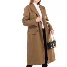 This Angora and Wool Coat by Dolce & Gabbana is a size IT 40 / XS and features a Silk Blend Lined interior. -This luxurious coat is made with a premium blend of angora and wool. -The silk lining adds a touch of elegance to this already stylish piece. -With a size IT 40 / XS, it offers a perfect fit for those looking for a high-quality coat. Designer Wool Coat For Work, Designer Wool Coat For Formal Fall Occasions, Luxury Double-breasted Wool Coat, Brown Tailored Luxury Wool Coat, Luxury Tailored Brown Wool Coat, Designer Fitted Wool Coat, Designer Long Wool Coat, Elegant Fitted Brown Wool Coat, Luxury Long Sleeve Wool Coat