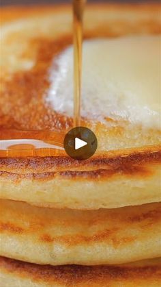 pancakes with syrup being poured onto them