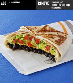 a burrito with black beans, lettuce and tomatoes