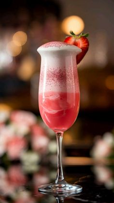 a drink in a glass with a strawberry on top