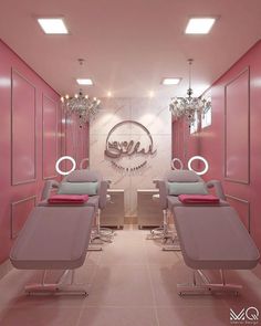 a salon with pink walls and chandeliers hanging from the ceiling