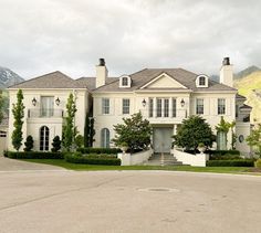 a large white house sitting on the side of a road