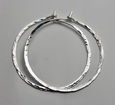 "Silver Hoop Earrings * Hammered Shiny Finish * 1 1/2\" Diameter (middle pair in second photo) * Handmade * Solid Sterling Silver These hoops are made of hand hammered 18 ga sterling silver. Approx. 1.5\" diameter. They are bent and hammered and then polished to a glittery shine by me. A basic essential to have. All items are presented in a 100% recycled paper box with a paper raffia bow. Thank you for looking at my shop. http://www.etsy.com/shop/tinysparklestudio 1 1/2\" silver hoops / silver h Silver Hoops Aesthetic, Hoops Aesthetic, Jewelry Hoop Earrings, Silversmithing Jewelry, Hoops Silver, Simple Hoop Earrings, Hammered Hoop Earrings, Sparkle Earrings, Hammered Silver