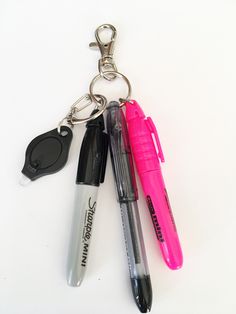 Nurse badge sharpie/pen clip comes with a mini Sharpie, a mini RSVP black ink pen in your choice of color (listed from selection box) , a mini light and mini highlighter in your choice of colors.  Sharpie, light, highlighter and pen are attached to a key ring which is attached to a lobster clasp which attaches easily to your name badge.  Being a nurse, I know how convenient it is to have such gadgets readily available.   Please choose your colors from the selection boxes. NOTE: INK PENS ALL COME Badge Reel Accessories, Mini Sharpie, Being A Nurse, Sharpie Pens, Mini Light, Bday Gifts, Post Grad, Pen Accessories, Joe Burrow