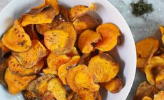 two white bowls filled with sweet potato chips