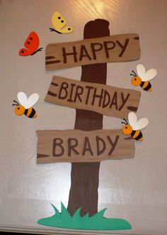 a birthday sign with bees and butterflies on it