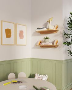 a dining room with green walls and wooden shelves on the wall next to a white table