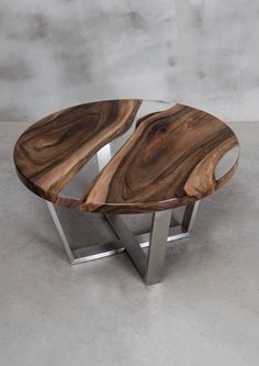 a wooden table sitting on top of a cement floor next to a metal frame wall