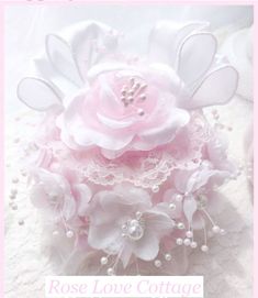 a close up of a pink flower on a white background with the words rose love cottage