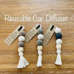 three necklaces with tasselled beads on them and the words reusable car diffuser