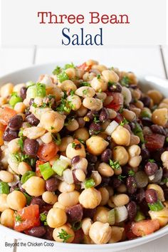 a white bowl filled with black - eyed beans and veggies on top of a table