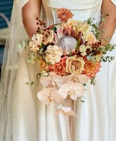 a bride holding a bouquet of flowers in her hands