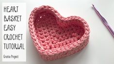 a crocheted heart sitting on top of a table next to a purple pen