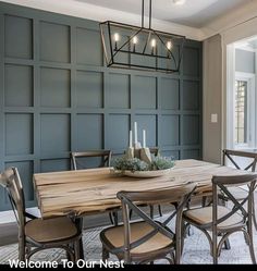 a dining room table with chairs and a chandelier