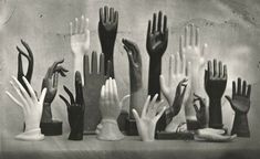 many different types of hands are shown in this black and white photo, with one hand reaching out to the other