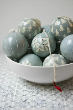 a bowl filled with blue and white decorated eggs