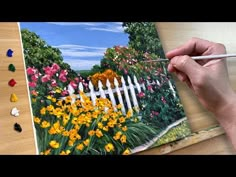 someone is painting a garden scene with flowers