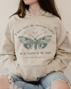 THE LUNA MOTH SHAKESPEARE HOODIE  We are super excited for you to get your hands on this new design Gildan hoodie. This product is very on trend and we hope you love it! 💜 If you would like to discuss any alternative size, color or product options, please do not hesitate to contact us directly. 💌 THIS DESIGN IS ALSO AVAILABLE AS A T SHIRT: ➡️ ➡️ ➡️ https://www.etsy.com/uk/listing/1393645140/shakespeare-moth-shirt-shakespeare-shirt ✨ ABOUT OUR HOODIES ✨ The material is a thick blend of cotton and polyester. This makes for a plush, soft feel alongside warmth. It also has a spacious kangaroo pocket that hangs in front. The hood's drawstring is the same color as the base sweater. The hoodies are 50% cotton and 50% polyester, medium-heavy fabric and a classic fit. Made from specially spun fib Dark Academia Hoodie, Fairy Grunge Hoodie, Masc Cottagecore Sweatshirts & Hoodies, Bleach Moth Hoodie, Fairycore Shirt, Shakespeare Shirt, Shakespeare Gifts, Moth Hoodie, Moth Sweatshirt