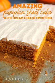 a cake with white frosting and orange pumpkins in the background on a baking sheet