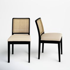 two black and white chairs with beige upholstered backrests on each side