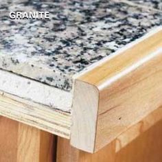 a close up view of a counter top with wood grain and stone work on it