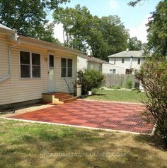 a brick patio in front of a house