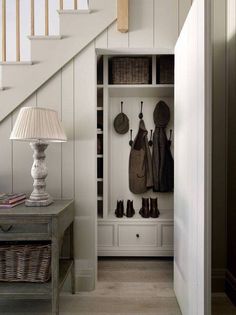 the entryway is decorated in white and features an open shelf with hooks, hats, and booties