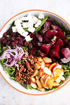 a salad with beets, carrots, apples, nuts and feta cheese